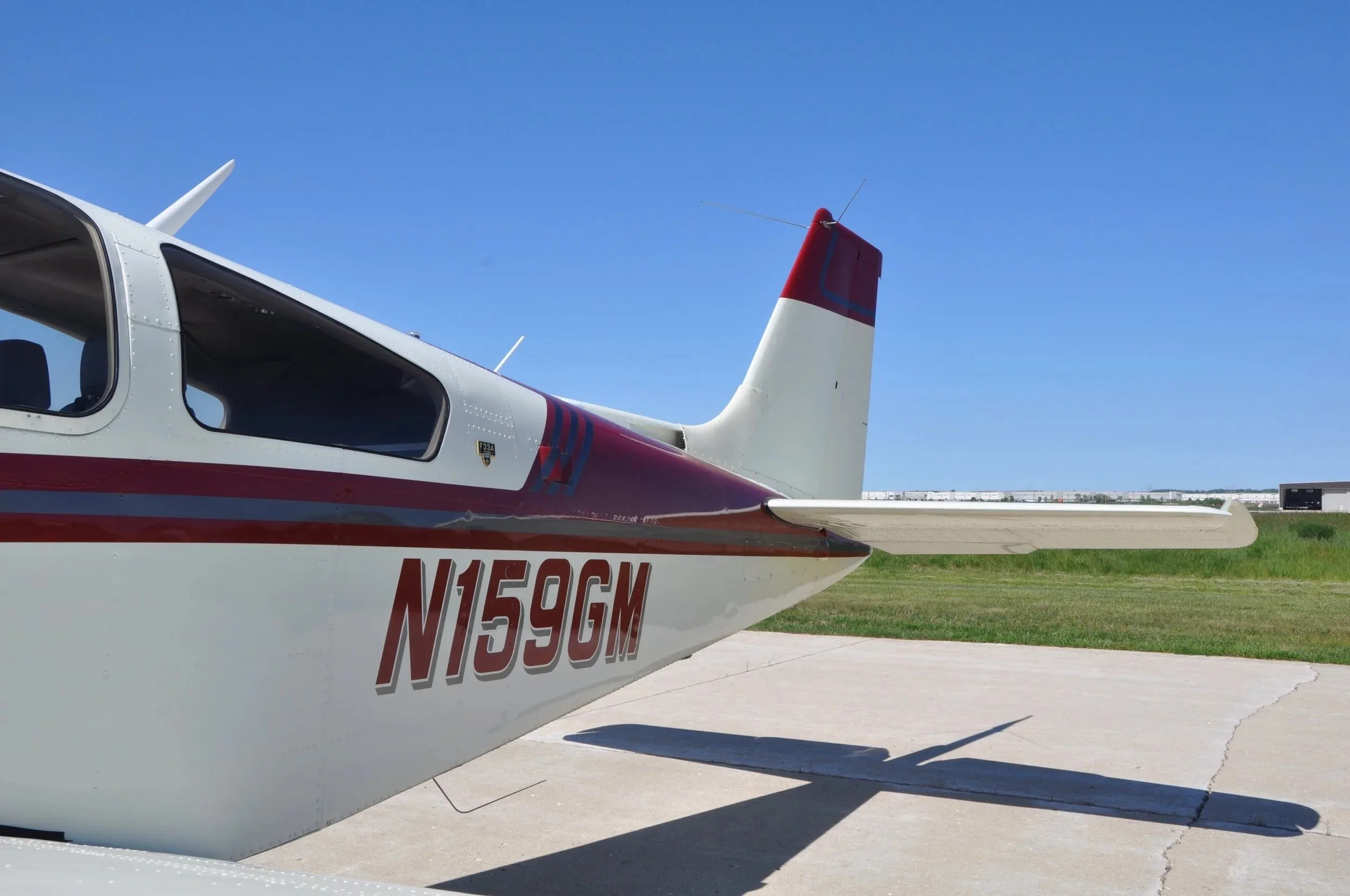 A close-up view of the tail section and rear fuselage of the Beechcraft Bonanza F33A N159GM.