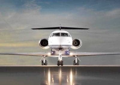 Front view of a private jet on the tarmac.