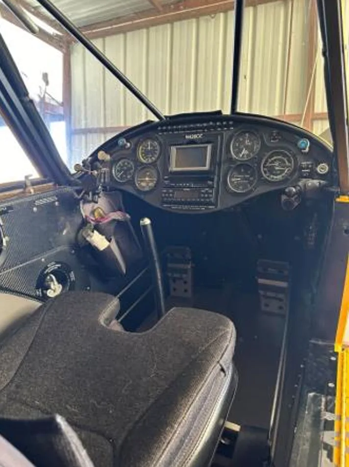 View of the cockpit of the Carbon Cub aircraft showing the instrument panel and seat.
