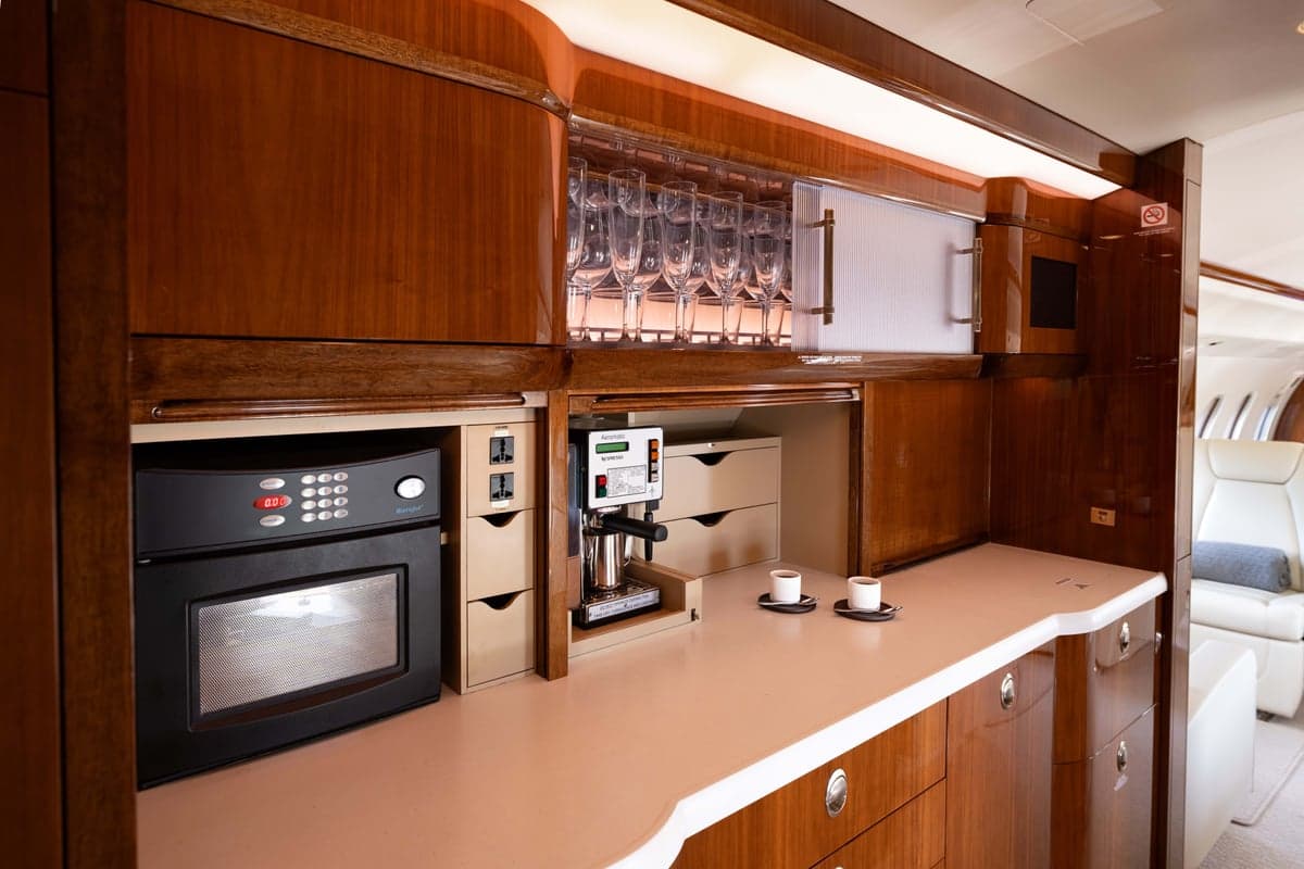 View of the aircraft interior with a bar and appliances.