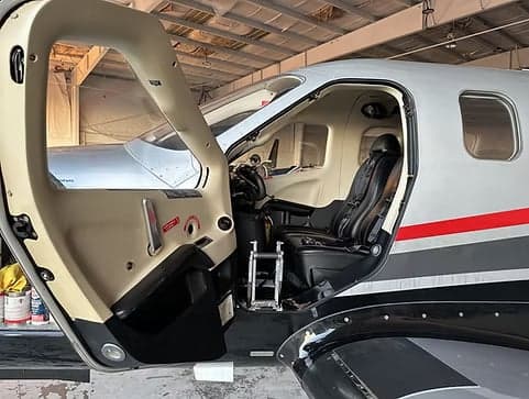 View of the cockpit and front seat of a TBM 930 aircraft.