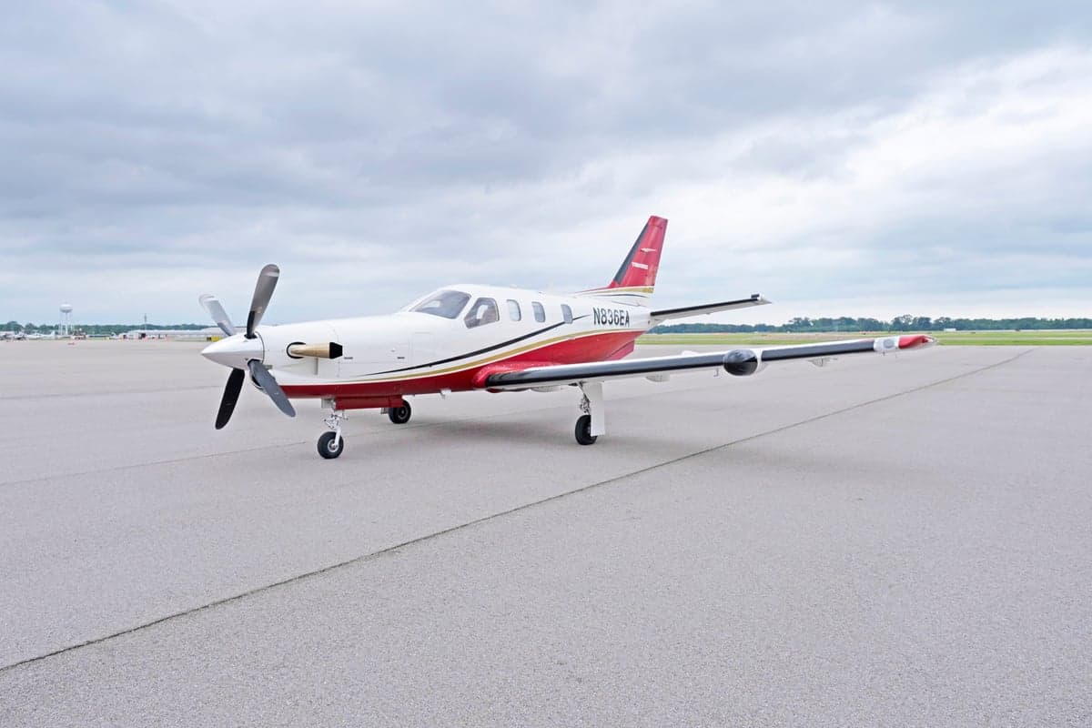 Side view of the TBM 850 aircraft N836EA on the tarmac.