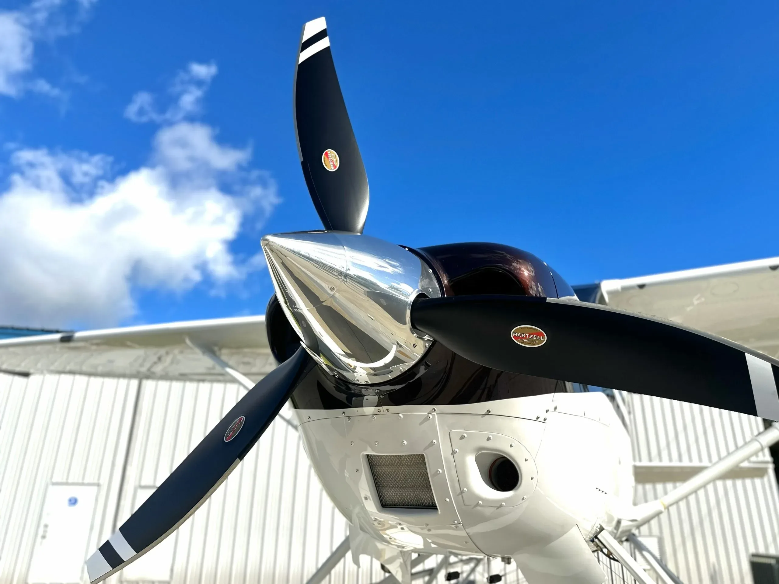 A front view of the Cessna seaplane's propeller and nose, featuring a polished spinner.