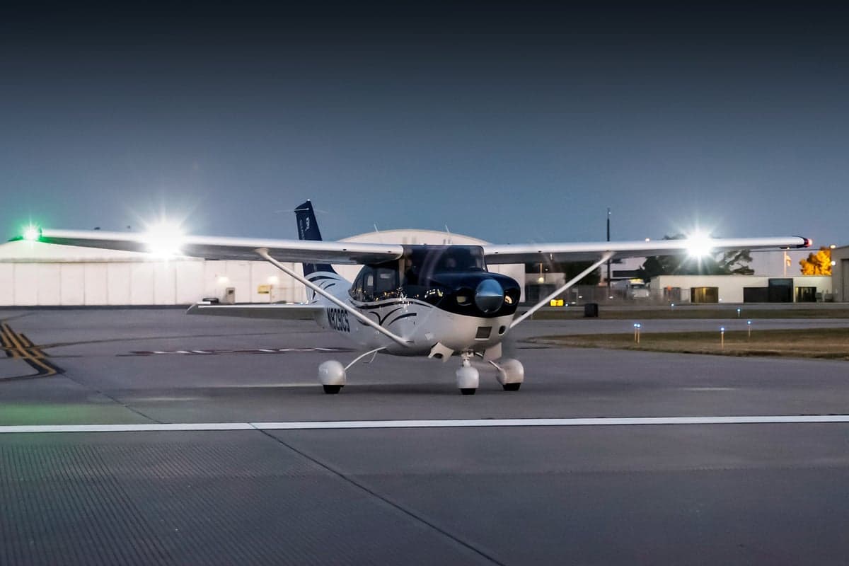 A Cessna Caravan on the tarmac at dusk.