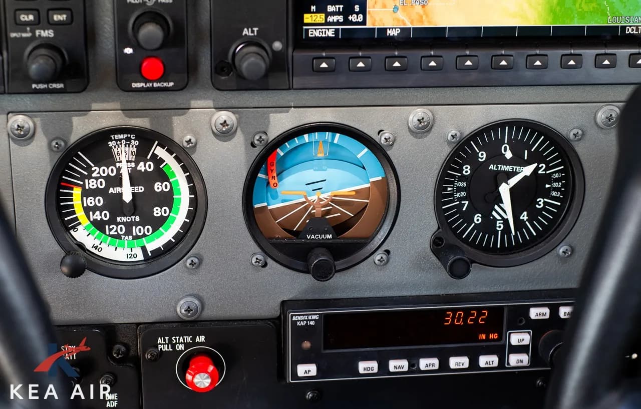Close-up of the aircraft's instrument panel, including the airspeed indicator, attitude indicator, and altimeter.