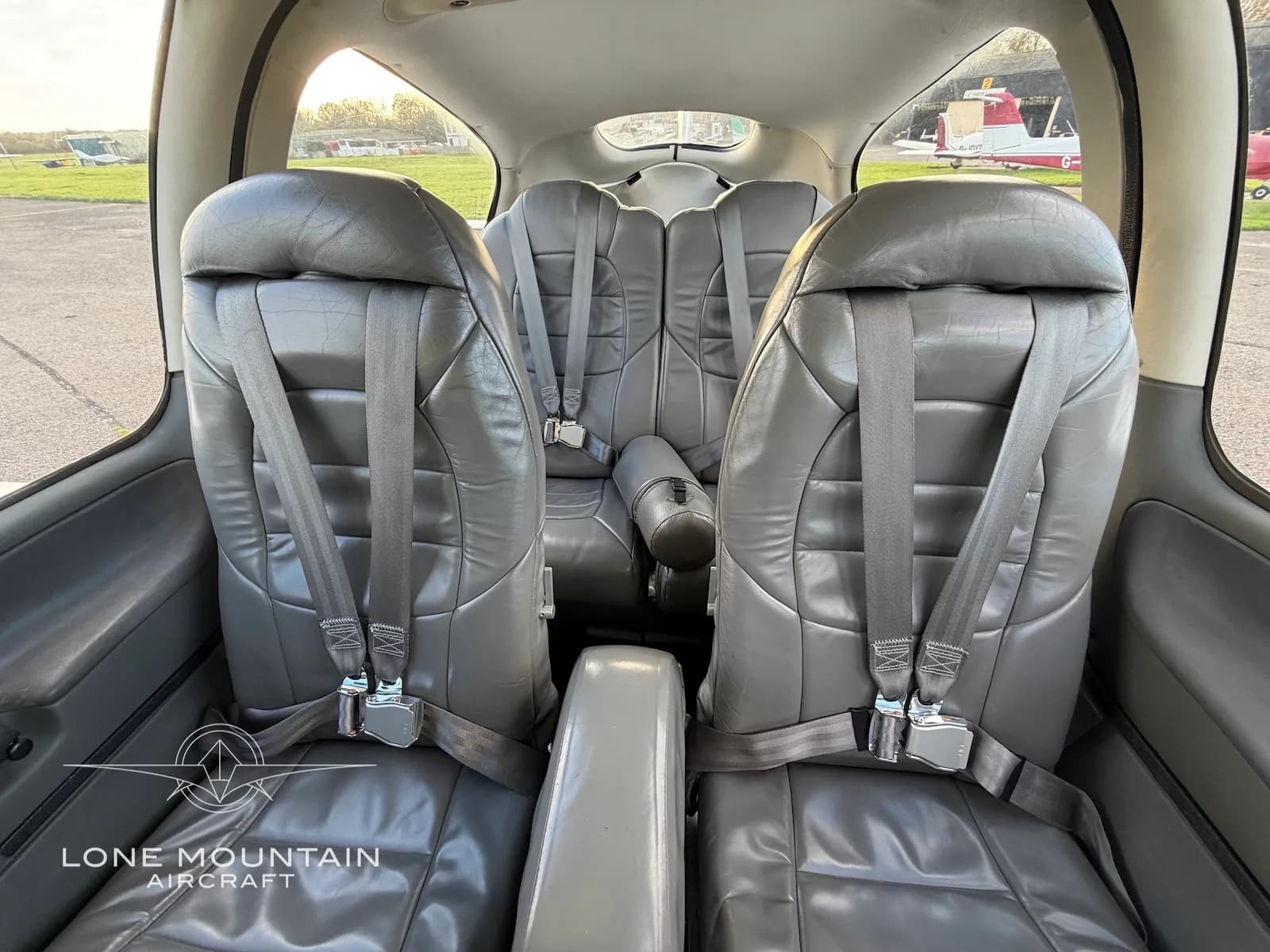 A view of the grey leather rear seats in the cabin of the Cirrus SR22 aircraft.
