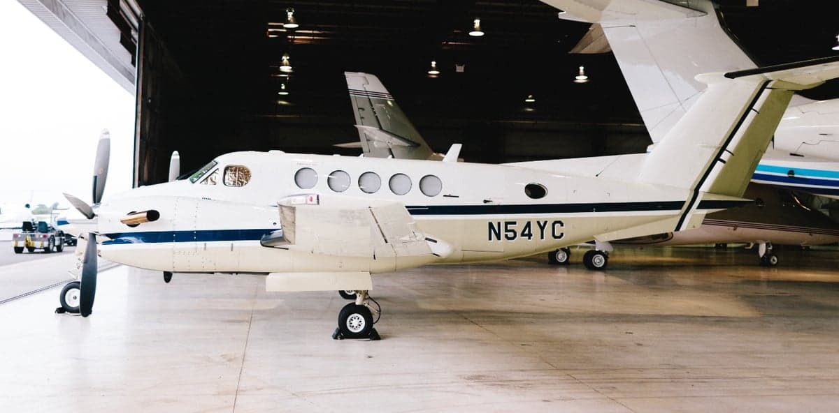 Side view of the aircraft N54YC in a hangar.