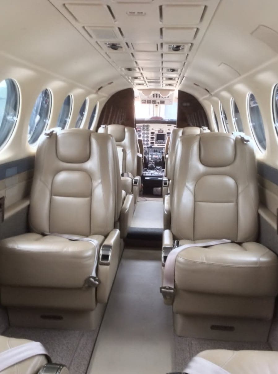 View of the aircraft cabin with leather seats and cockpit.