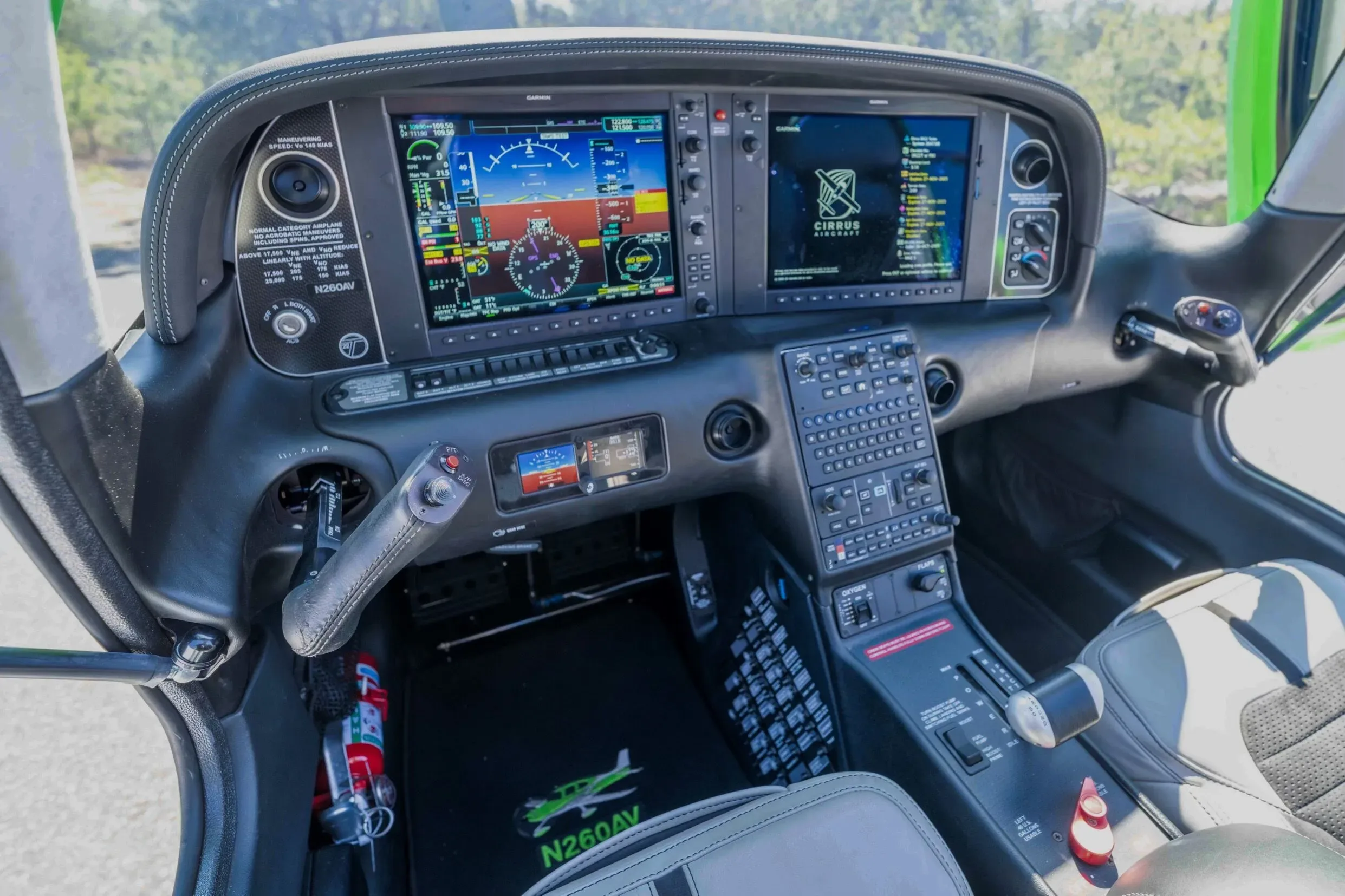The modern glass cockpit of the Cirrus SR22T aircraft, featuring dual Garmin displays and a side yoke.
