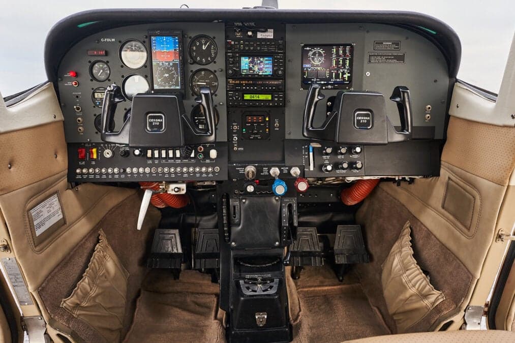 Full instrument panel and controls in the cockpit of a Cessna 210.