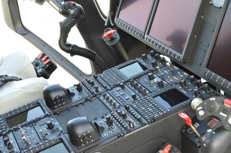 Interior view of a helicopter cabin with blue and black seats.
