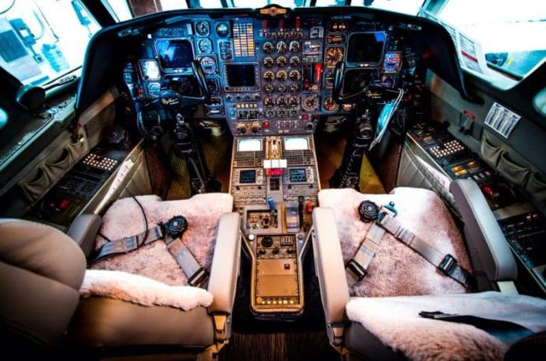 Cockpit view with instrument panel and seats.
