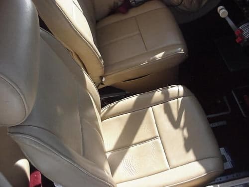 The interior of the aircraft features tan leather seats.