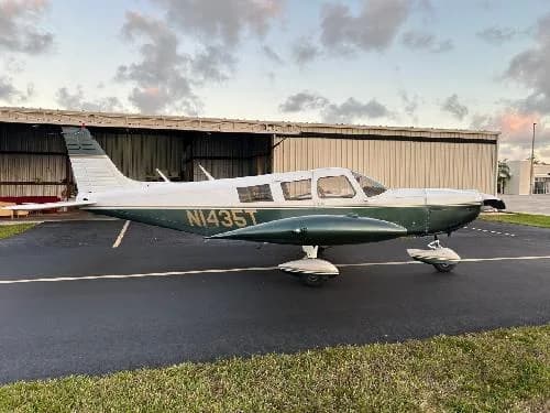 Side view of Piper PA-28-181 Archer II aircraft N1435T parked on the tarmac.