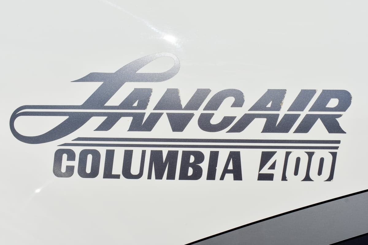 Close-up of the Lancair Columbia 400 logo on the aircraft's exterior.