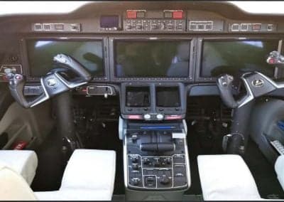 The cockpit of the aircraft features multiple display screens and controls.