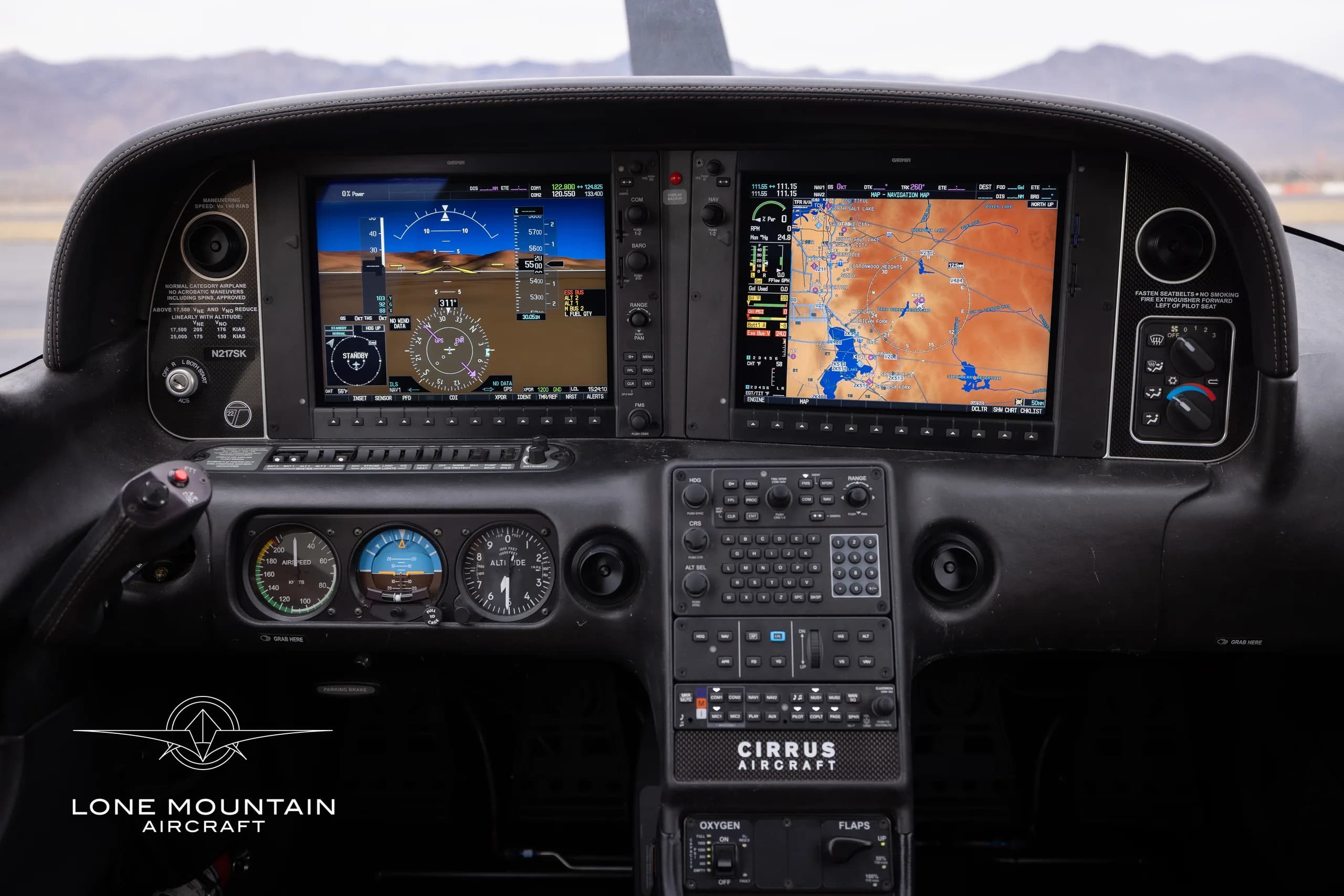 The cockpit of a Cirrus SR22T aircraft with dual screens and a black instrument panel.