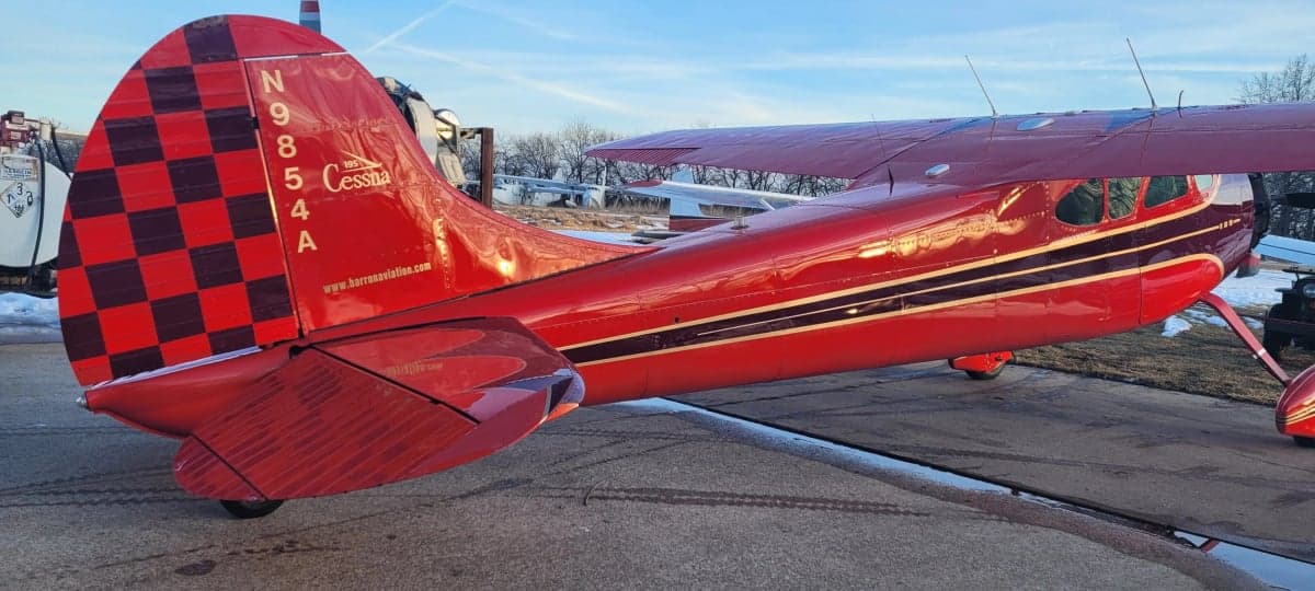 Tail section of the red and black Cessna 195, registration N9854A.