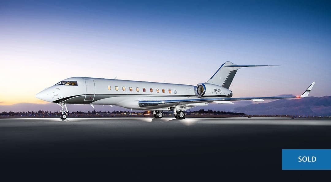 A Bombardier Global Express, registration N40TE, is parked on the tarmac at dusk.