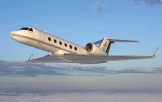 Gulfstream G450 in flight over clouds.