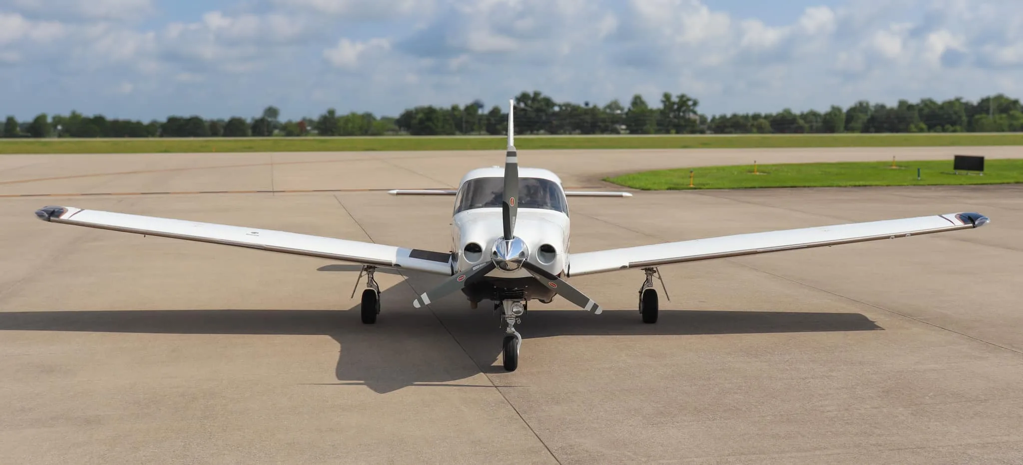 A head-on view of the Piper Saratoga II TC aircraft, N540WB, parked on an airfield.