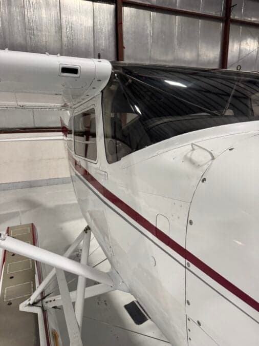 Close-up of the Cessna 206 fuselage and wing.