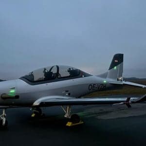 A silver CEAD aircraft sits on the tarmac.