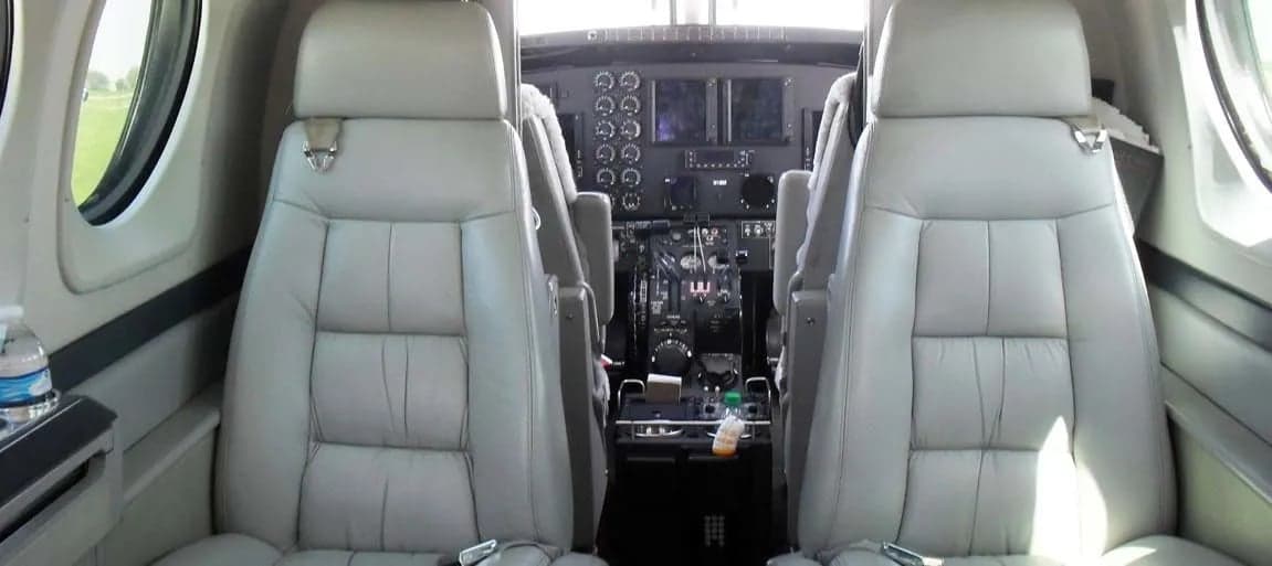 View of the cockpit and forward cabin seats of the aircraft.