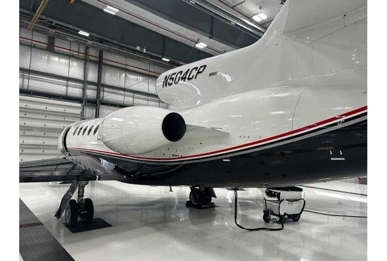 Rear side view of the N504CP aircraft in a hangar.