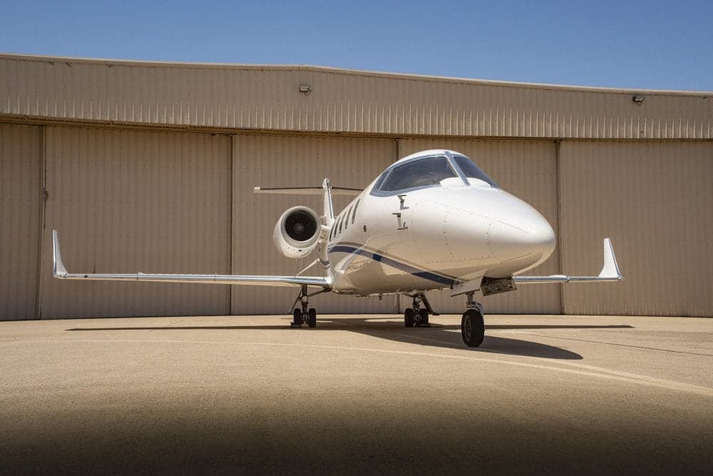 Front view of a Learjet 45XR parked on the tarmac.
