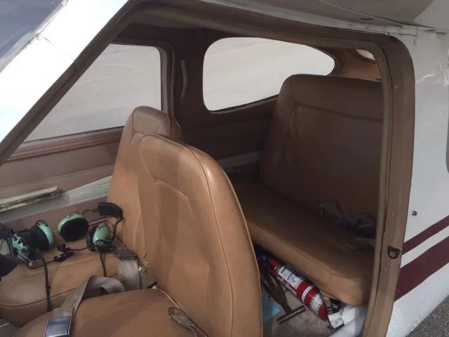 Interior view of the Cessna 177 Cardinal cabin, showing the seats and fire extinguisher.