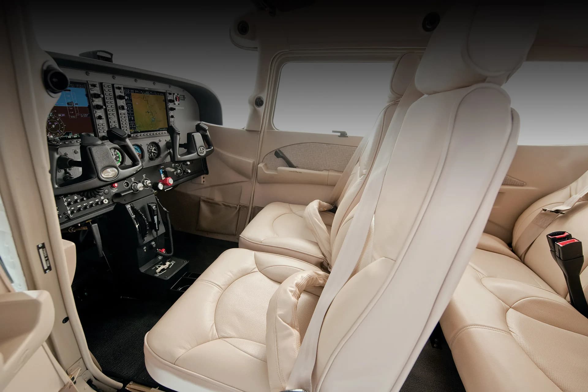 View of the aircraft's interior, showing the cockpit and front seats.