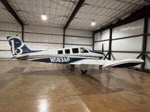 N563AP Bonanza aircraft in a hangar, side view.