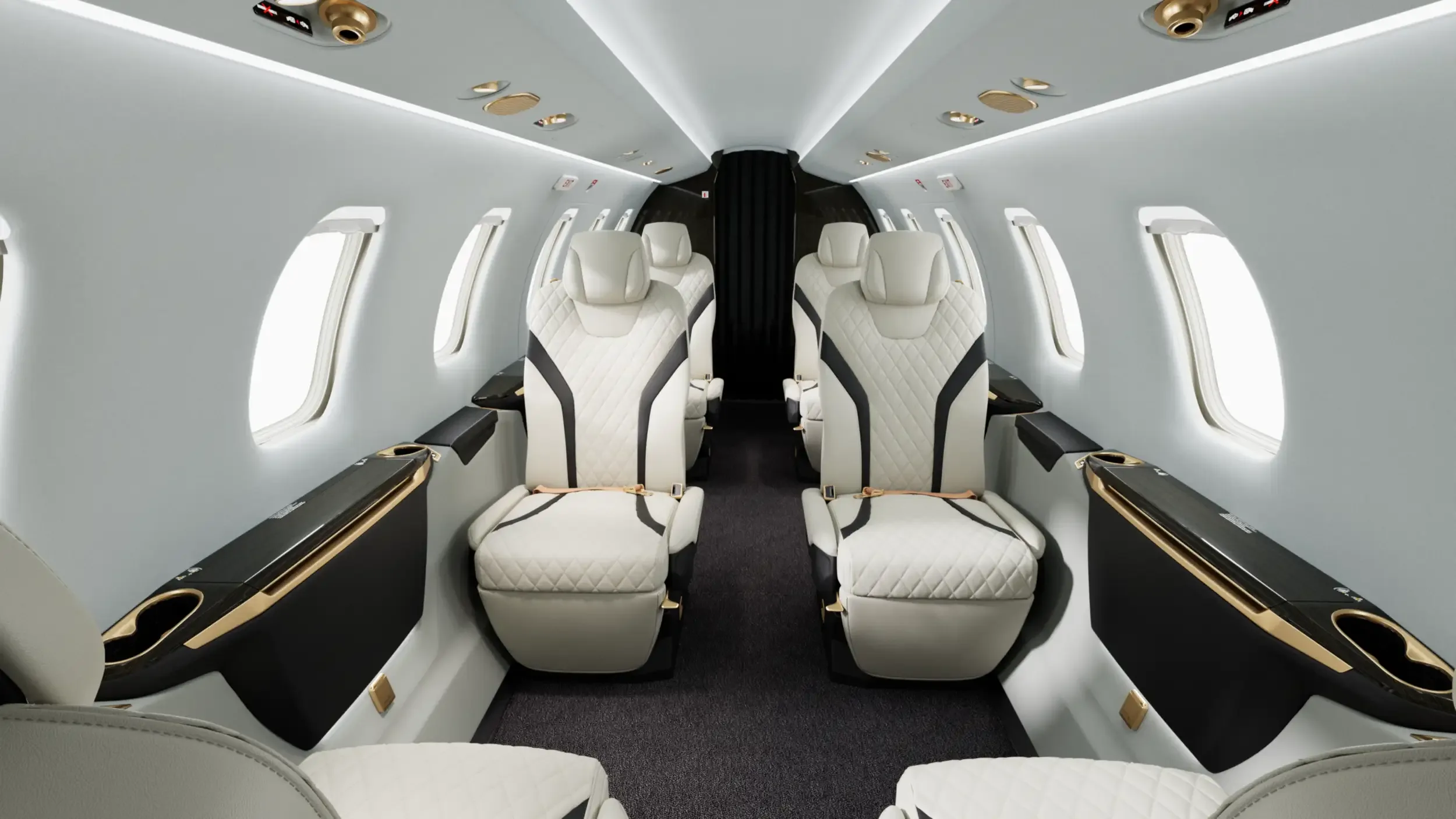 Wide view of the aircraft interior with white leather seats.