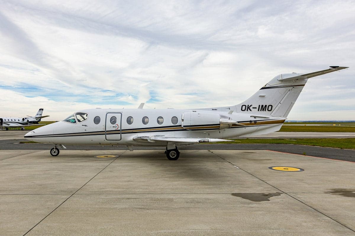 Side view of the Beechjet 400A aircraft with registration OK-IMO on the tarmac.