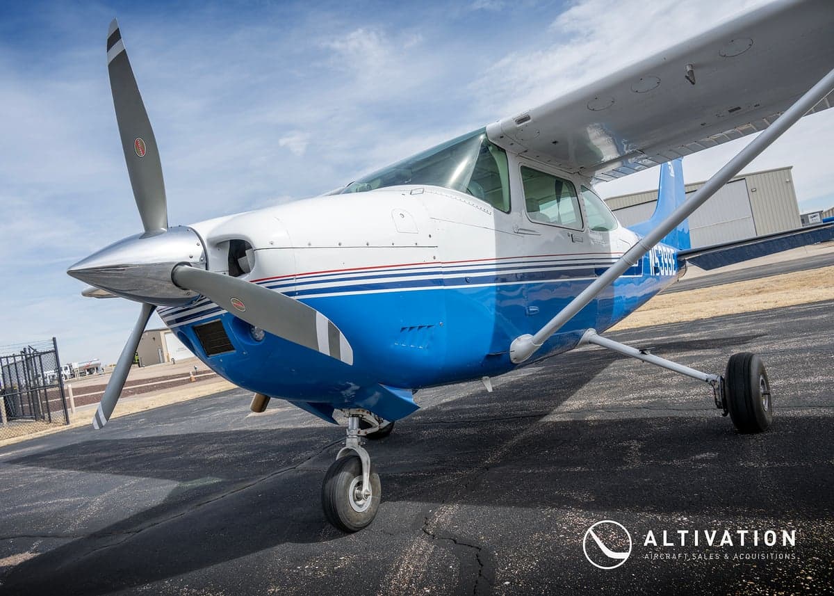 The rear seats of a Cessna aircraft, upholstered in a two-tone pattern.