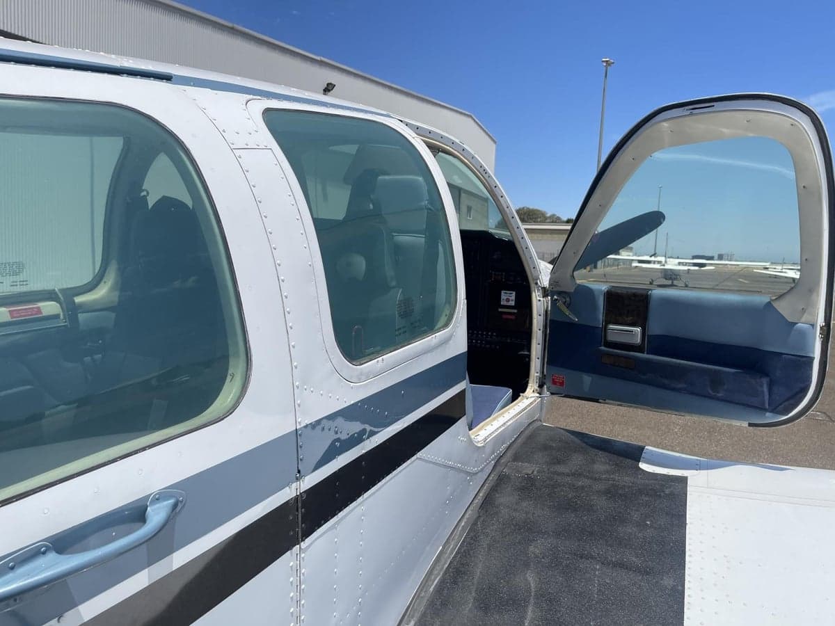 Side view of the aircraft with the door open, showing the interior.
