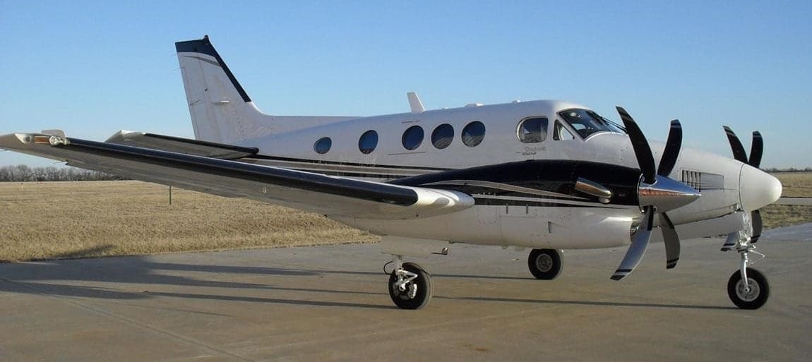 A Beechcraft King Air is parked on the tarmac.