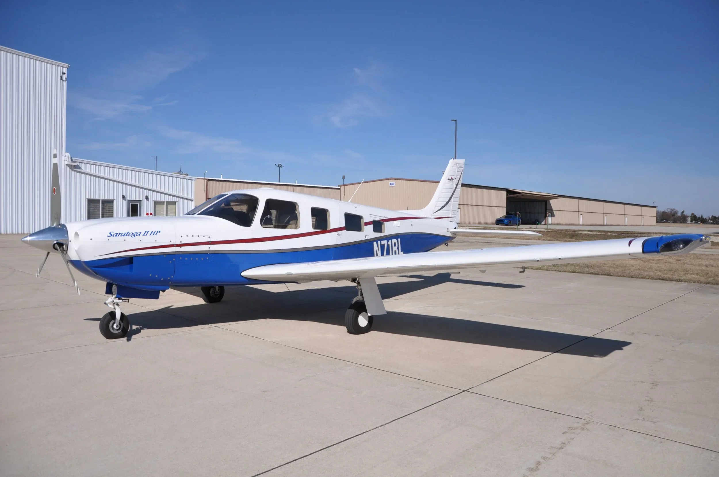 A Saratoga II HP aircraft with registration N71RL is parked on the tarmac.