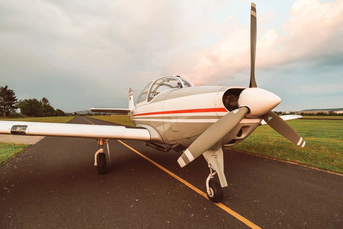 The D-EGWK aircraft is parked on the runway with a gray and white paint scheme.