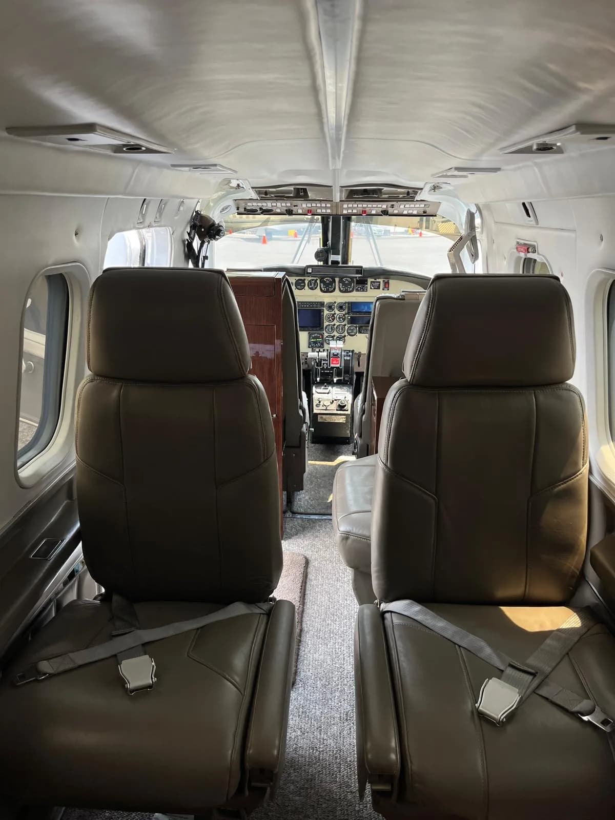 View of the aircraft's interior, showing the leather seats and cockpit.