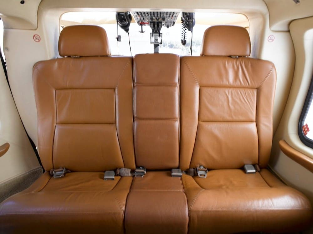 Rear cabin seats upholstered in brown leather.