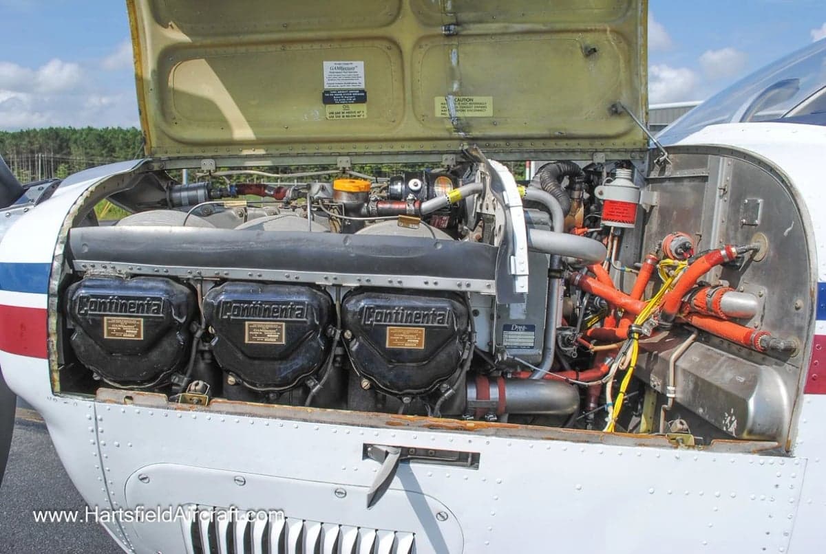 Close-up of the Continental engine of a Beechcraft Bonanza with the cowling open.