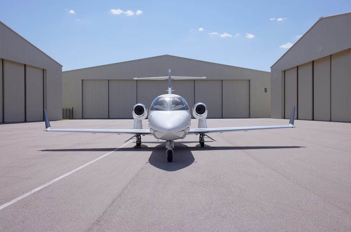 Front view of a HondaJet HA-420 parked on the tarmac.
