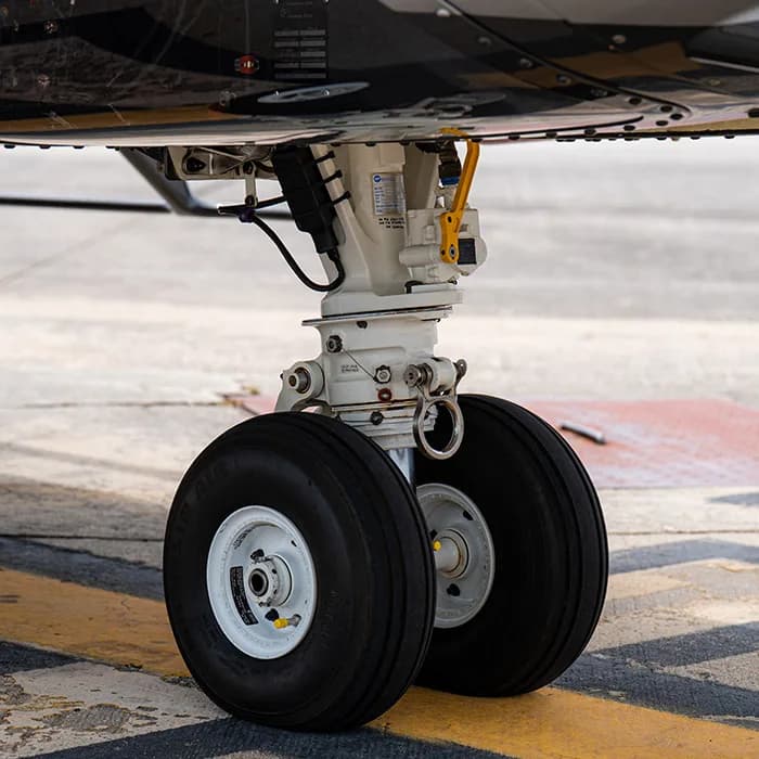 Close-up of the helicopter's landing gear and tires on the tarmac.