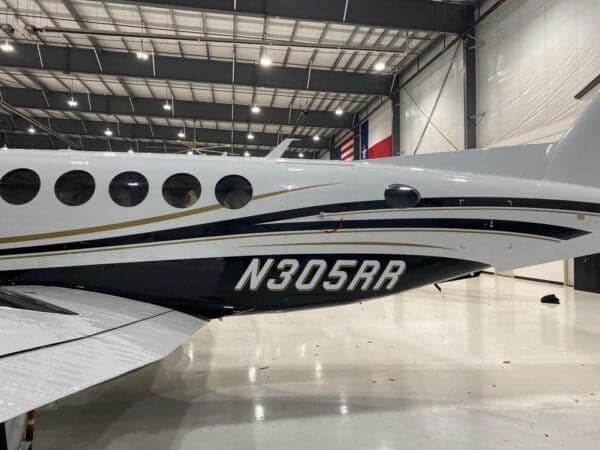 Close up of the tail section of a Beechcraft King Air 350 showing the tail number N305RR.