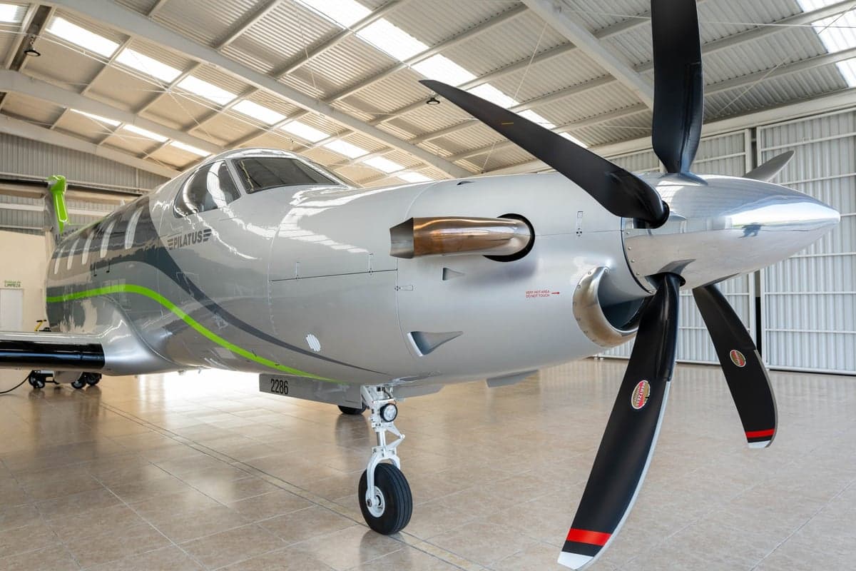 Close-up of the front of the Pilatus PC-12 aircraft with registration N676SG, showing the propeller and nose.