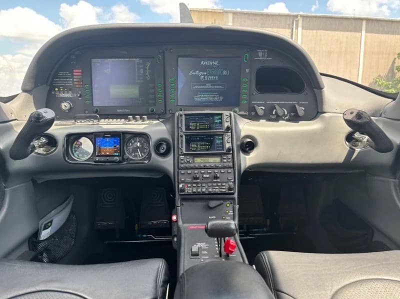 View of the cockpit dashboard with dual Avidyne Entegra glass displays and traditional radio stack.