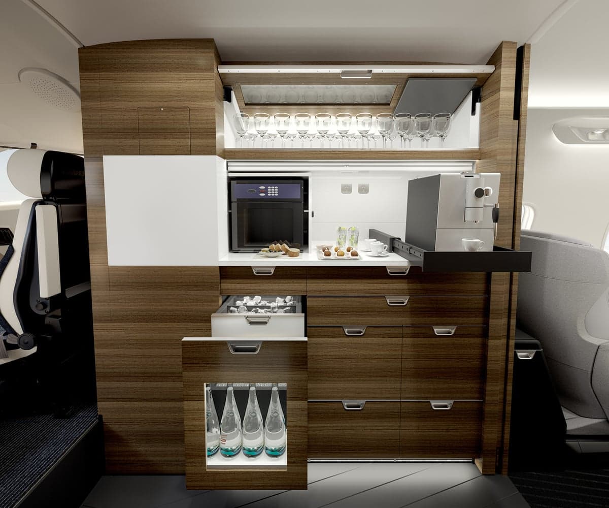 A view of the Challenger 3500 cabin with a refreshment center.