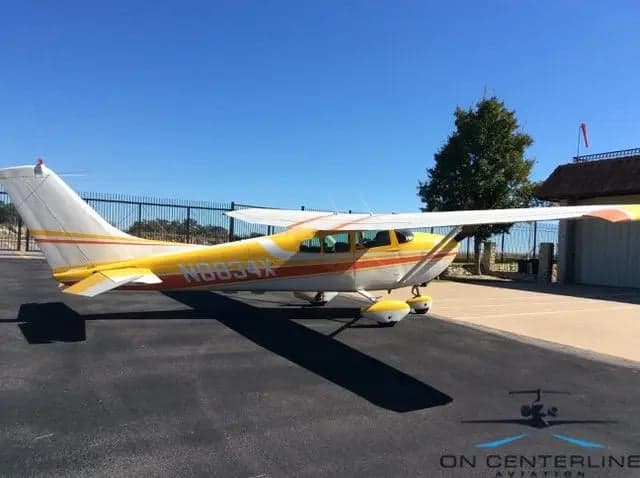 N8834X Cessna 172 Skyhawk with yellow and orange paint scheme, side view.